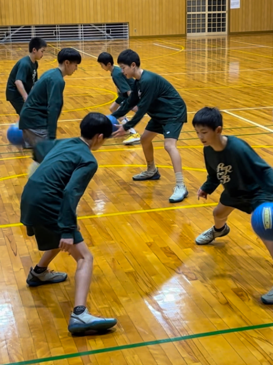 スクール生がペアになってバスケットボールの練習している様子の写真